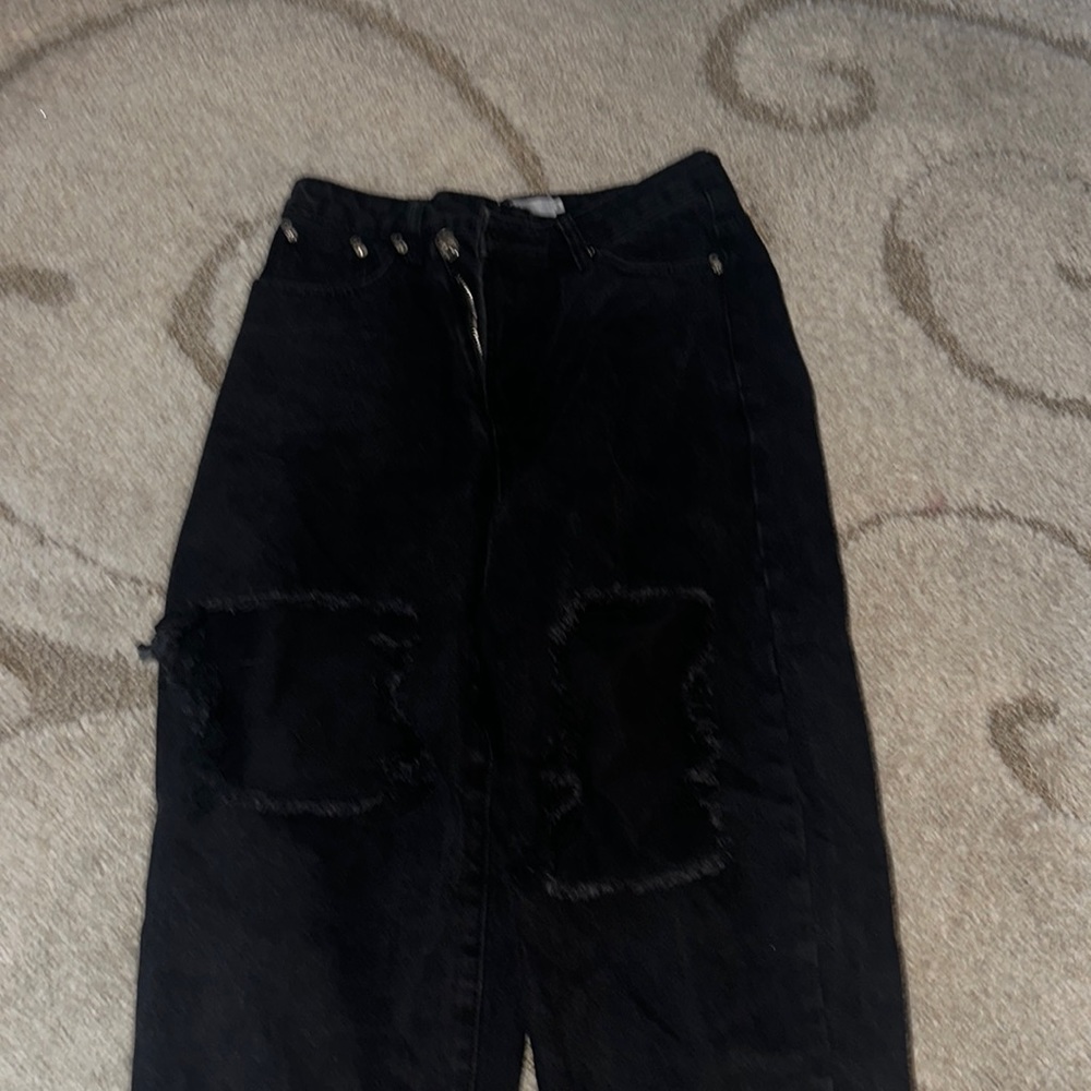 Black high-rise baggy jeans with the seam cut at the bottom